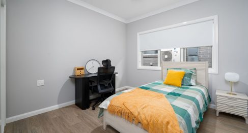 staff bedroom with desk and single bed