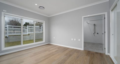 bedroom of SDA apartment with a view out of the large windows